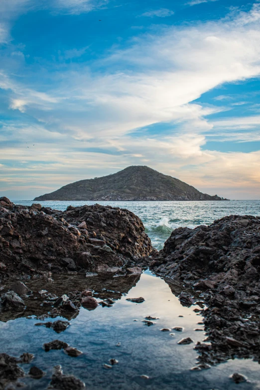 a mountain sits on a large rock formation