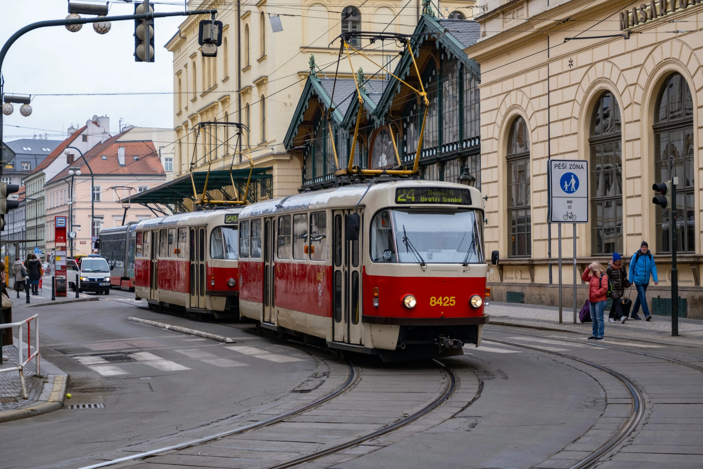 a tram on a track in front of a building