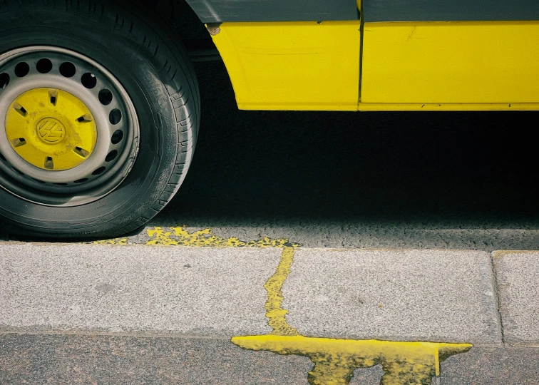 a yellow and black bus parked next to the curb