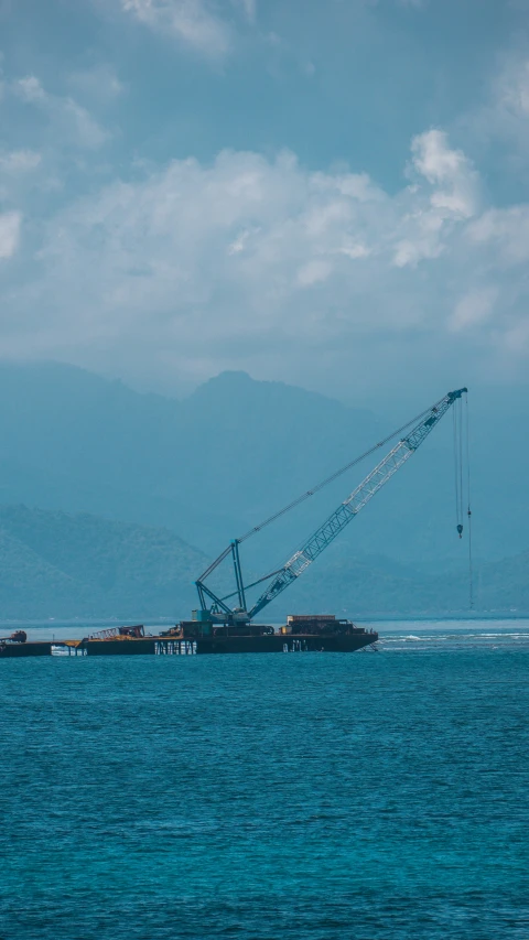 the crane is lifting off of a boat