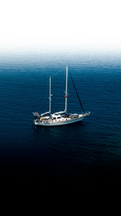 an aerial view of a boat sailing in open water