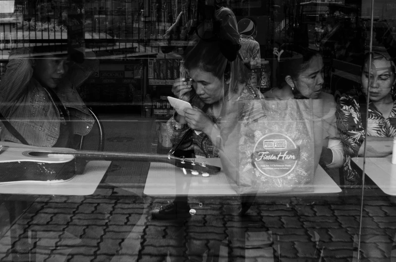a black and white po of people behind a glass window