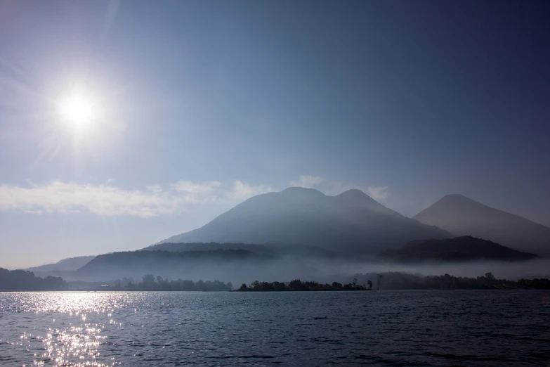 the sun shines over a mountainous mountain range