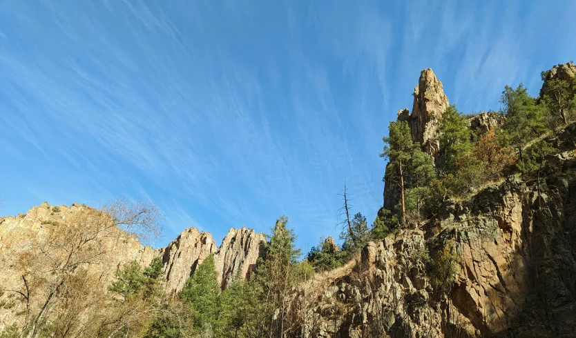 the sky above some mountains that is very high