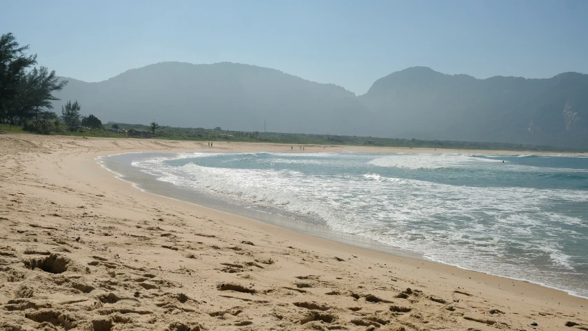 a beautiful beach with lots of sand and a para sail on it