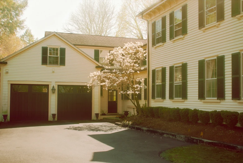 an empty driveway with three garages at the end of it