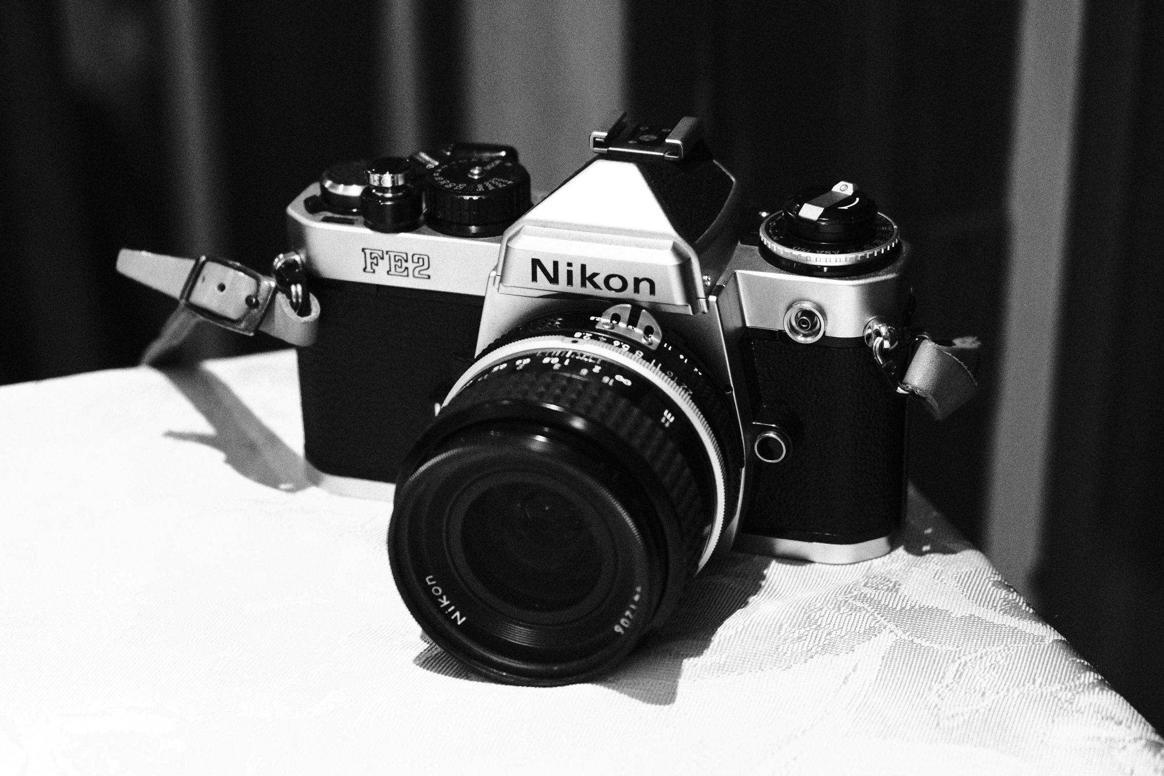 an old camera sitting next to another camera