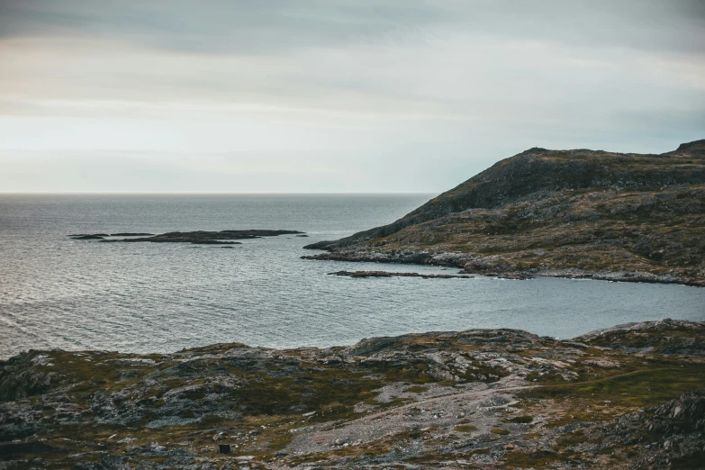 a lake with water on a rocky hill