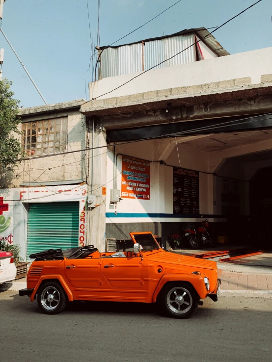 a classic pick up truck parked near a storage garage