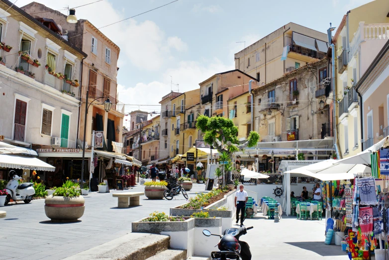 the city has several streets that have tables, and a row of store fronts