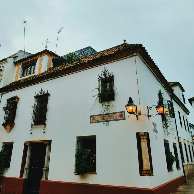 a white building with several windows and some balconies