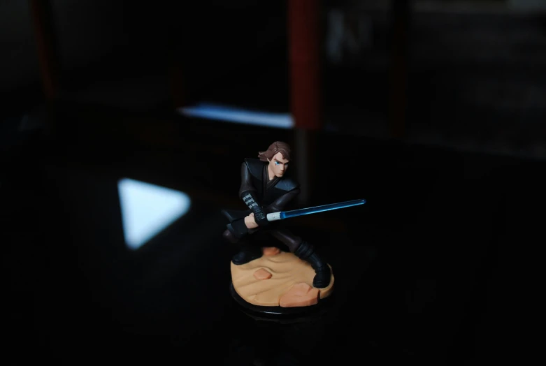 a figurine is posed on a small table