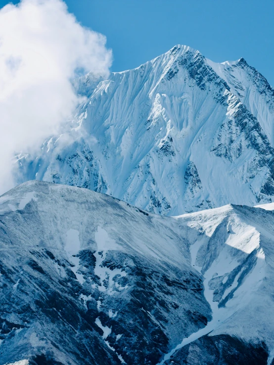 snow covered mountains under a bright blue sky