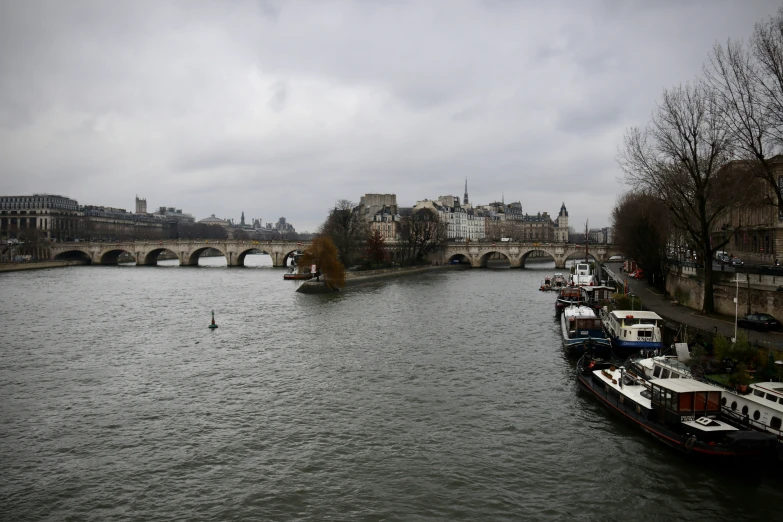 a view of boats floating on a river in an older area