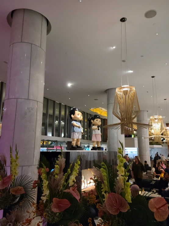 a decorated chandelier inside a building with stuffed bears and flowers