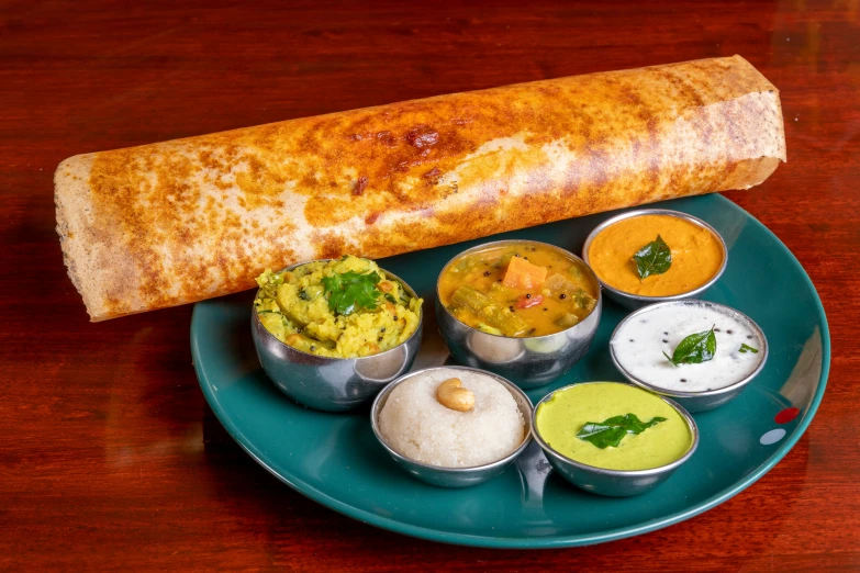 indian bread rolls with different dips on a plate