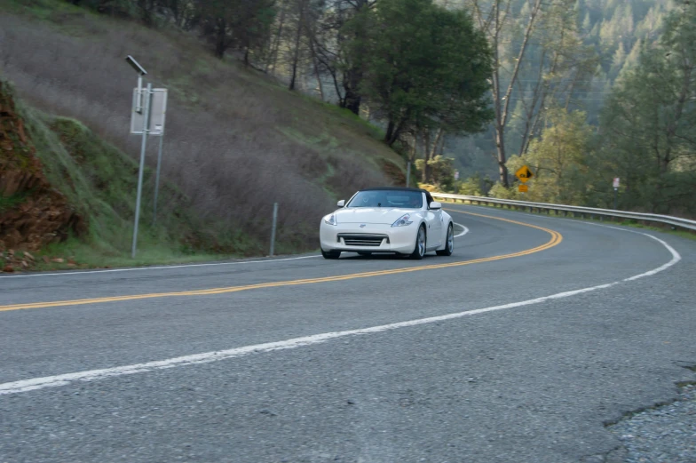 a car driving on the road down a hill