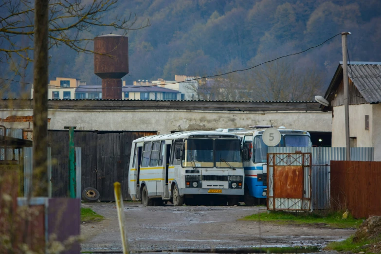 a very large city bus parked next to a big old house