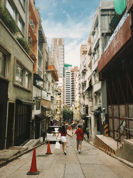 a couple of people are walking down a street