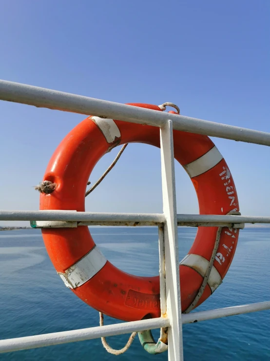 an orange life saver rests on the edge of a pier