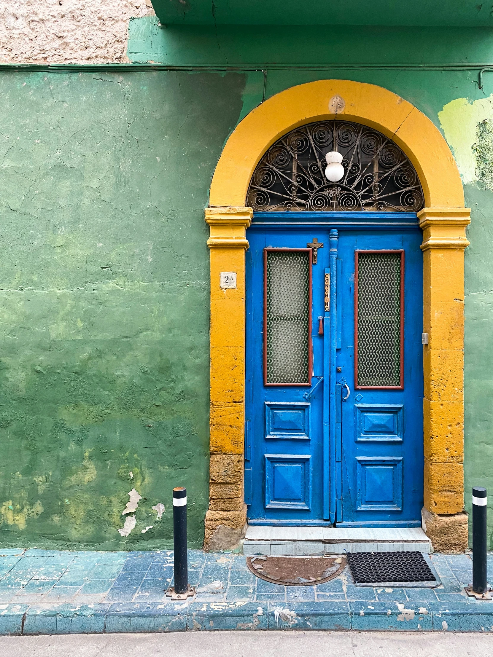 blue doors on a green and yellow building