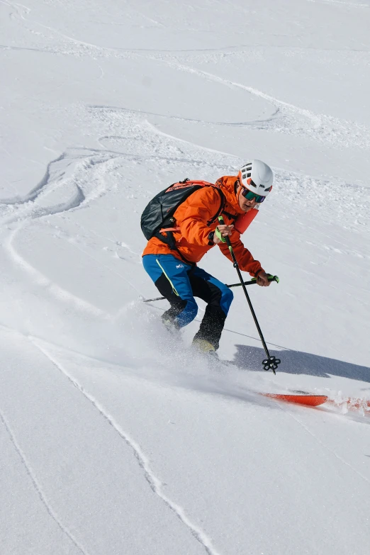 a person riding skis down a snow covered slope