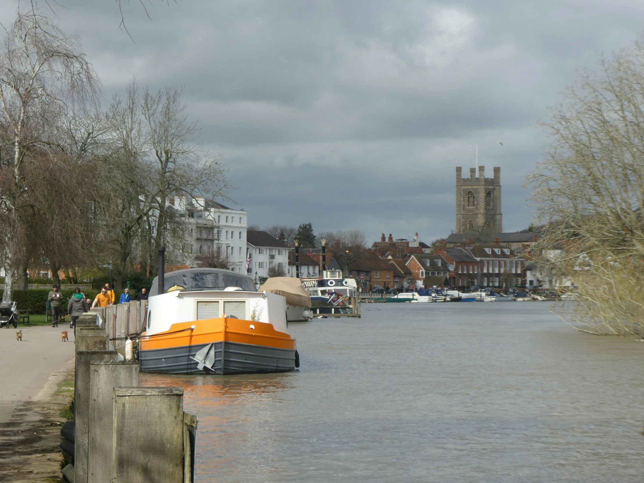 the boat is out on the river next to the buildings