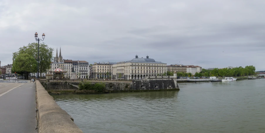 a picture from the river shore looking towards a town