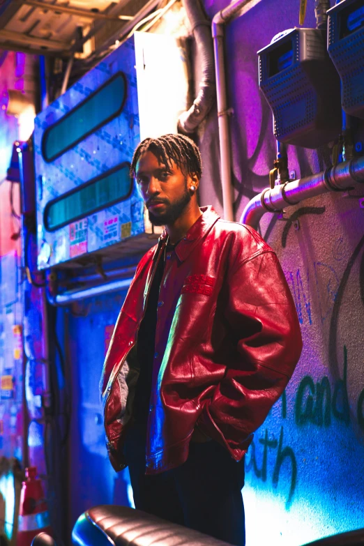 a young man wearing a red jacket and tie poses for the camera