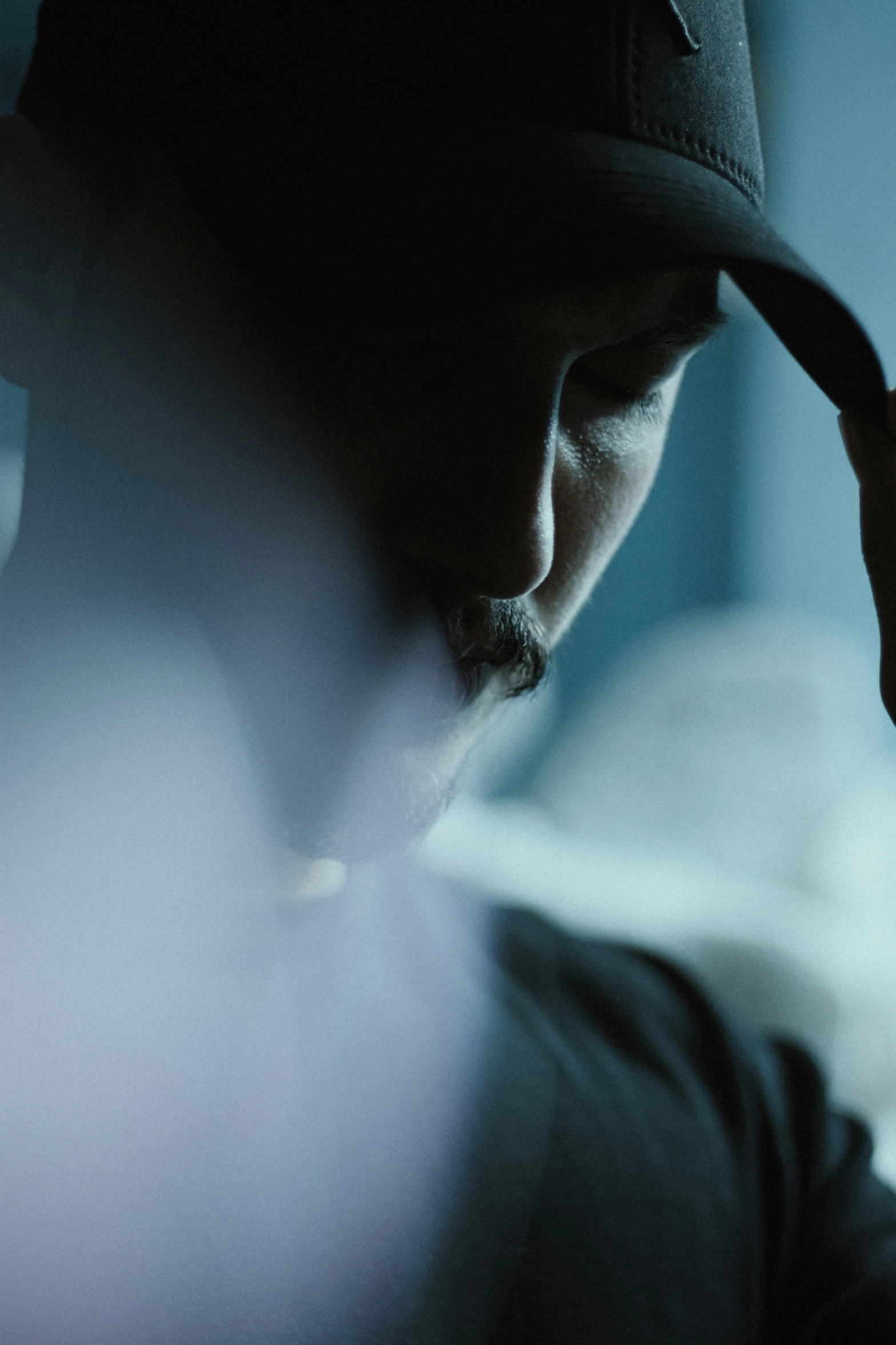 man wearing hat while talking on cell phone