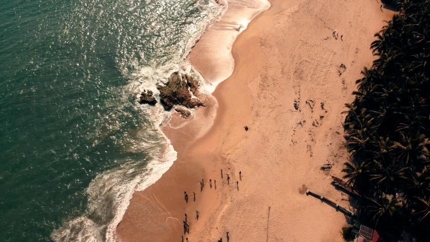 an overhead view shows the beach with clear blue water