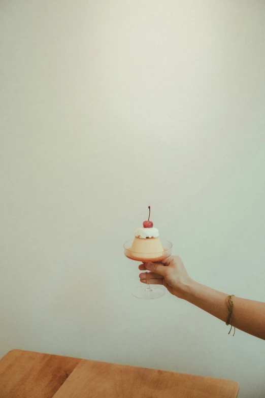 a woman holding a small pastry in her hand