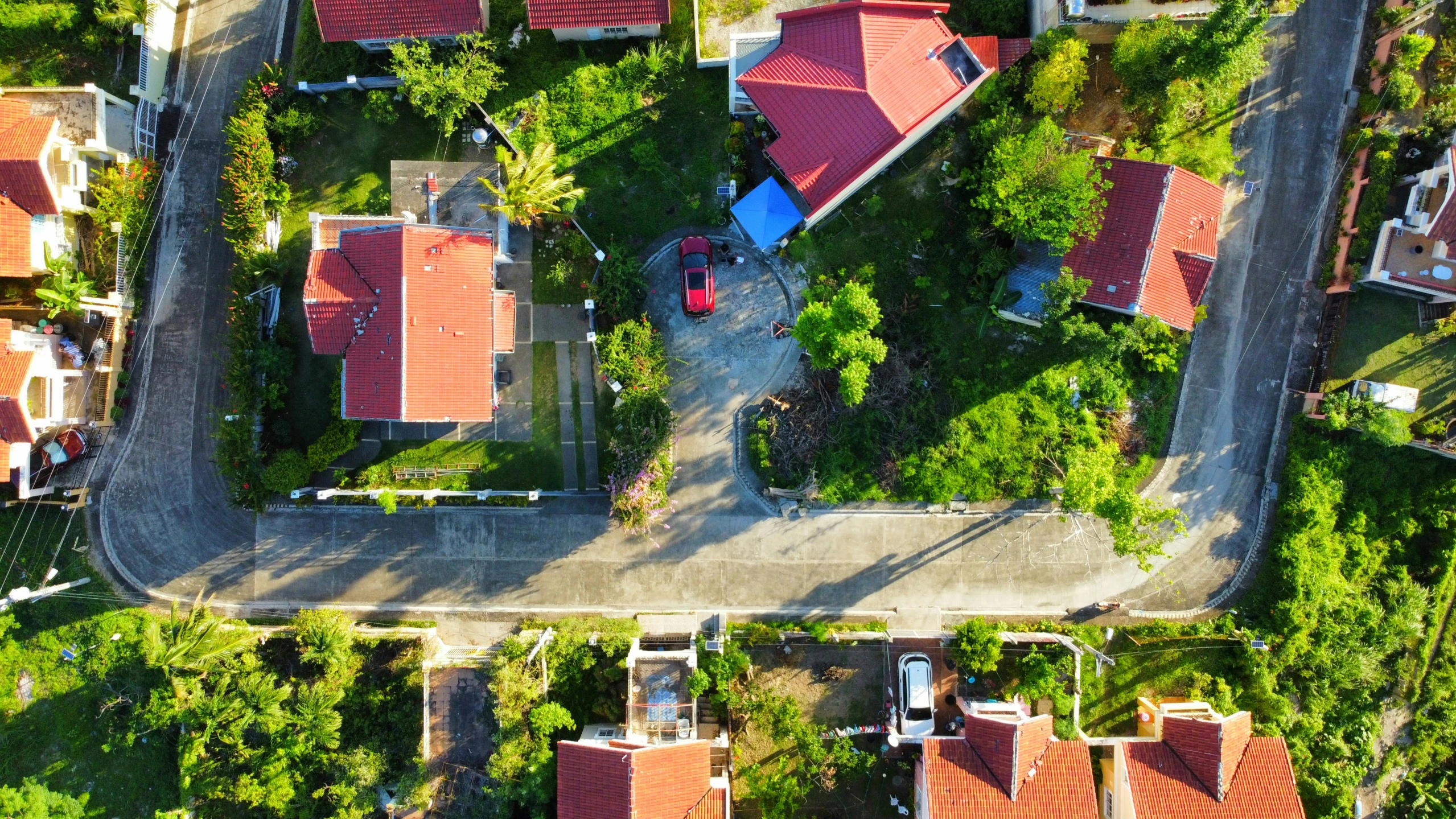 an aerial s shows some houses along a paved street