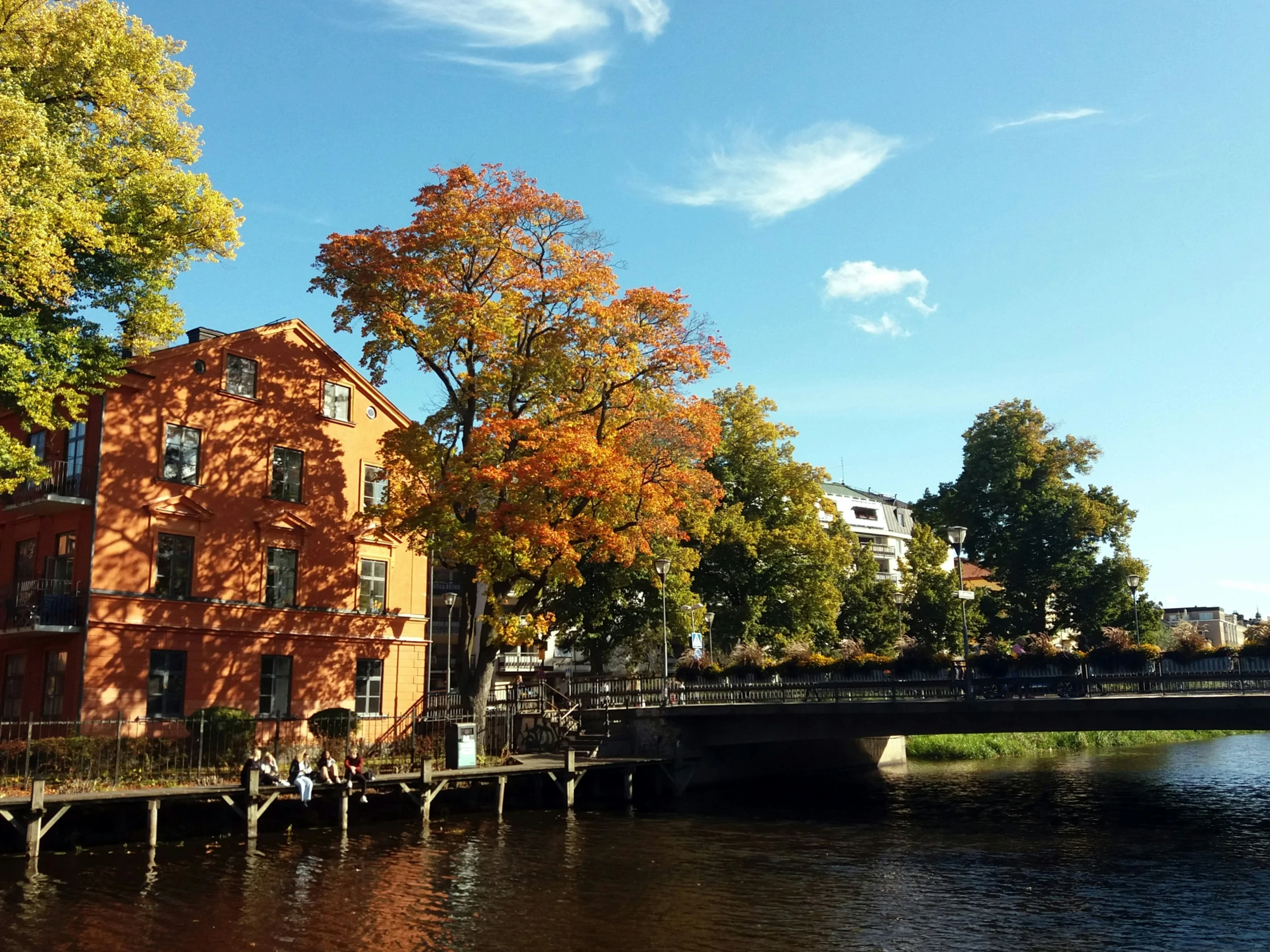 an orange building is next to a body of water