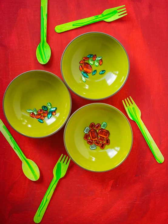 yellow dishes with green fork and greenware, some cut up on the table