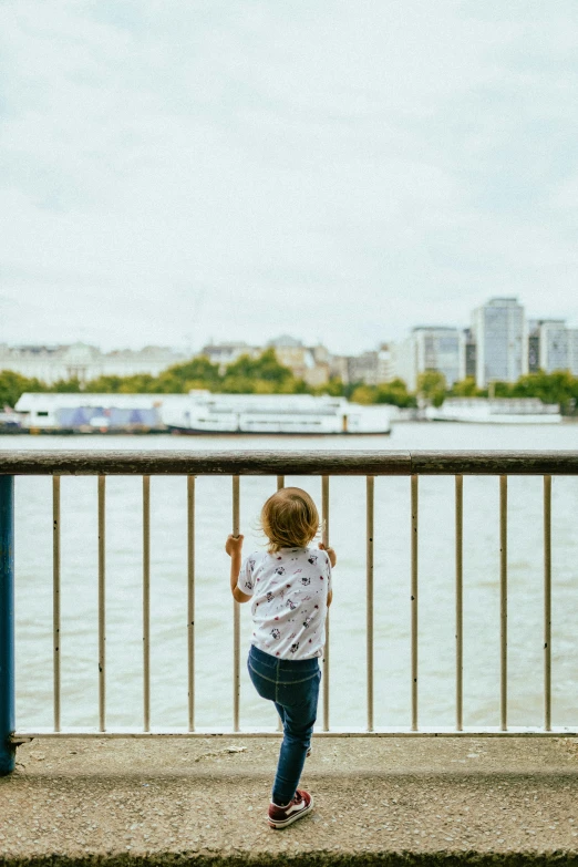 a  in white is jumping from a dock near the water