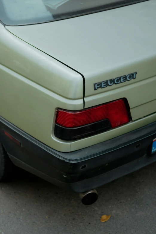 a beige car that is sitting on the road