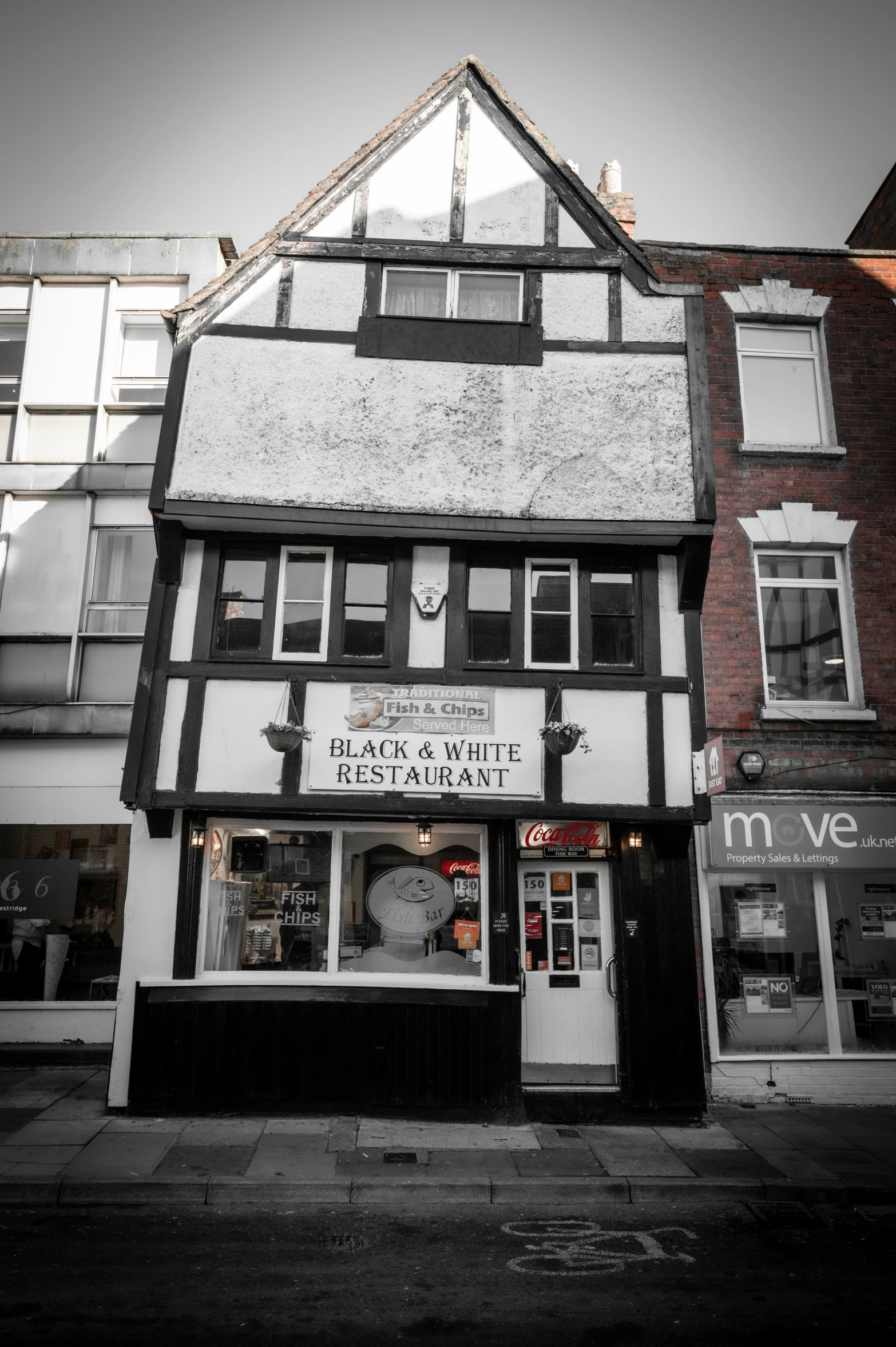 a black and white picture of a shop building