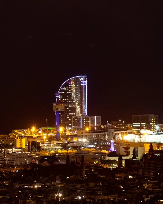 a city skyline with buildings lit up at night