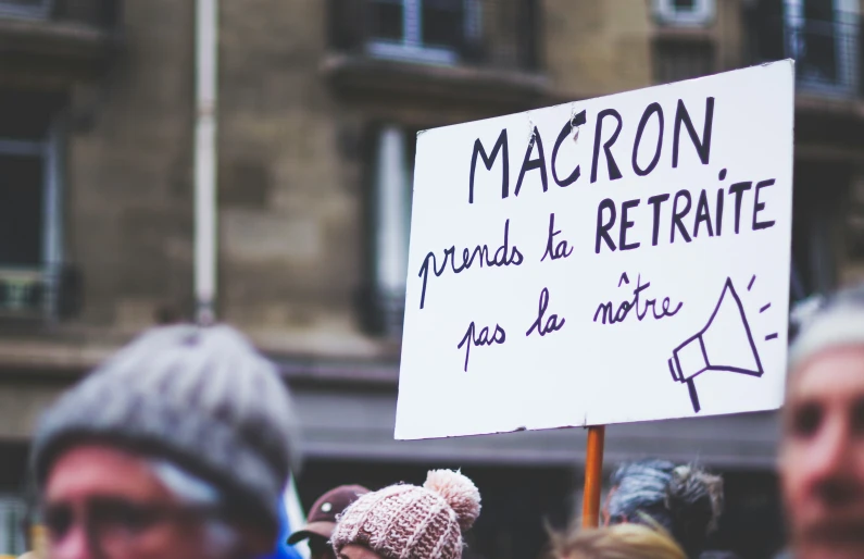 people hold a sign and a protest in france