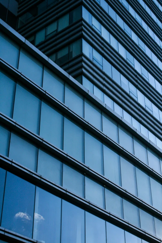 the windows of an office building against the blue sky