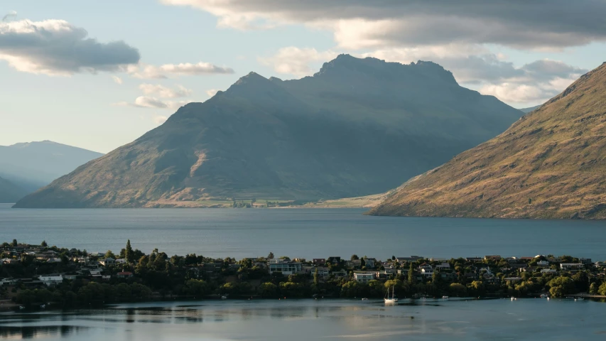 the small town is nestled in the mountains by the water