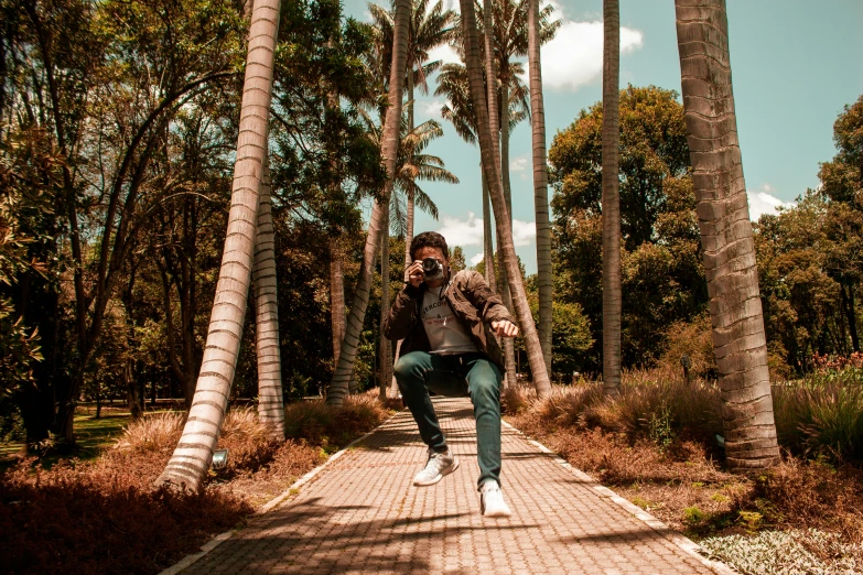 a man is on a walkway with palm trees