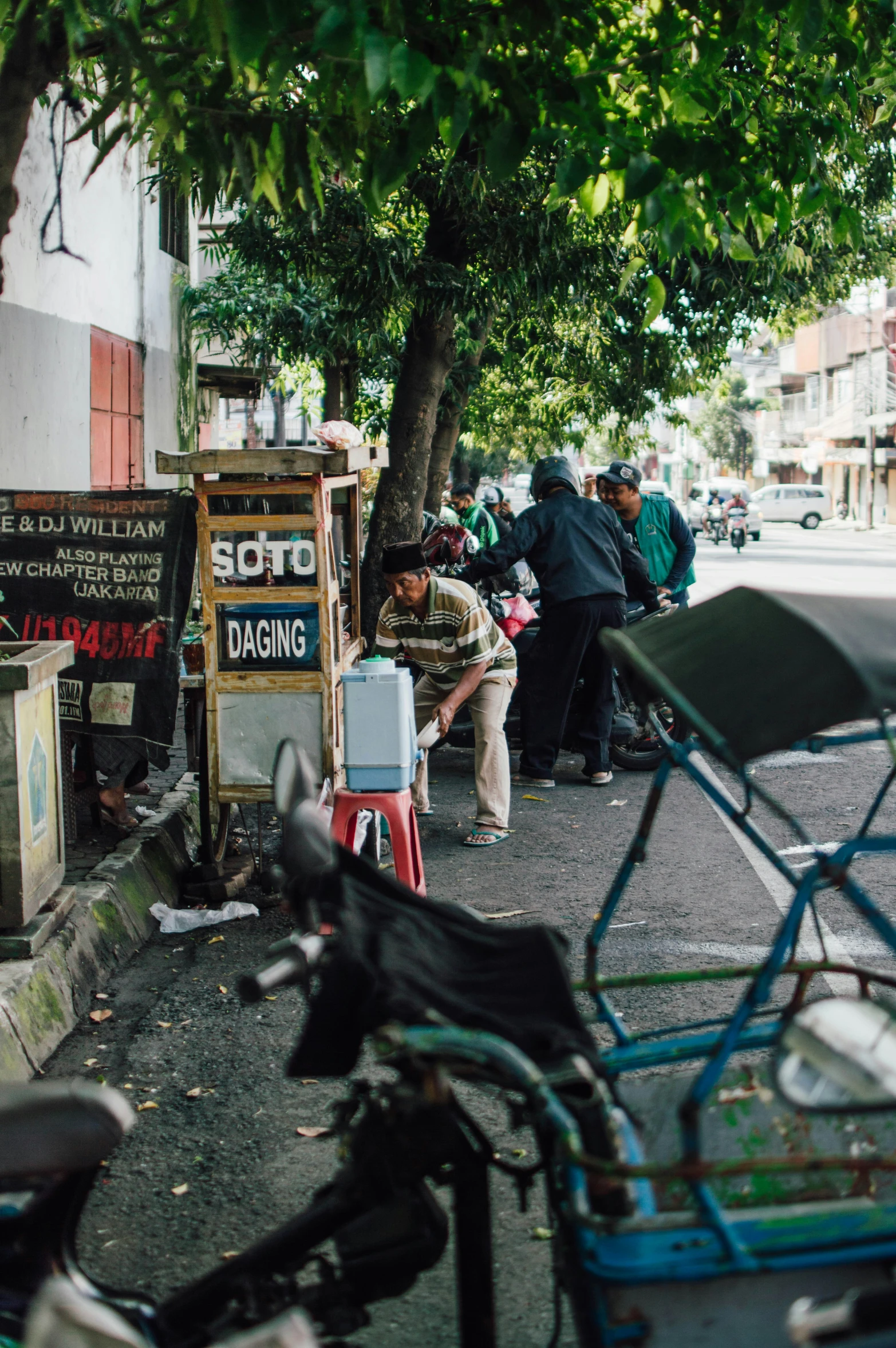 a number of bicycles parked near a sign and some people