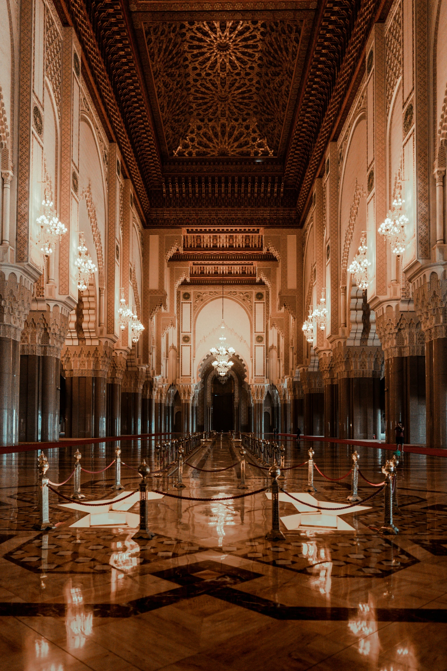 a hall with lights, chandeliers and pillars