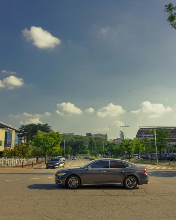 a car is parked on the street with a sky background