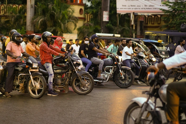 a couple of people riding motorcycles down a street