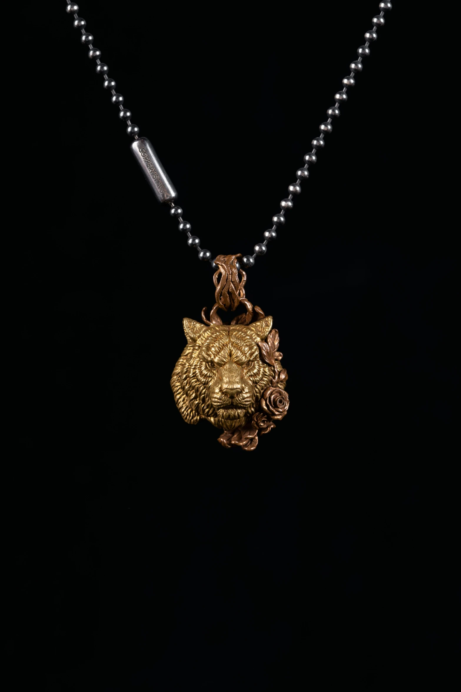 necklace with a decorative gold statue