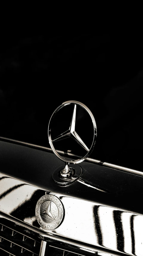 a mercedes emblem with a black and white po of it