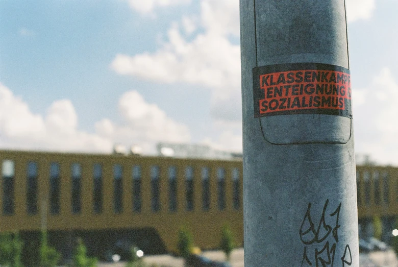 the back end of a street pole with graffiti on it